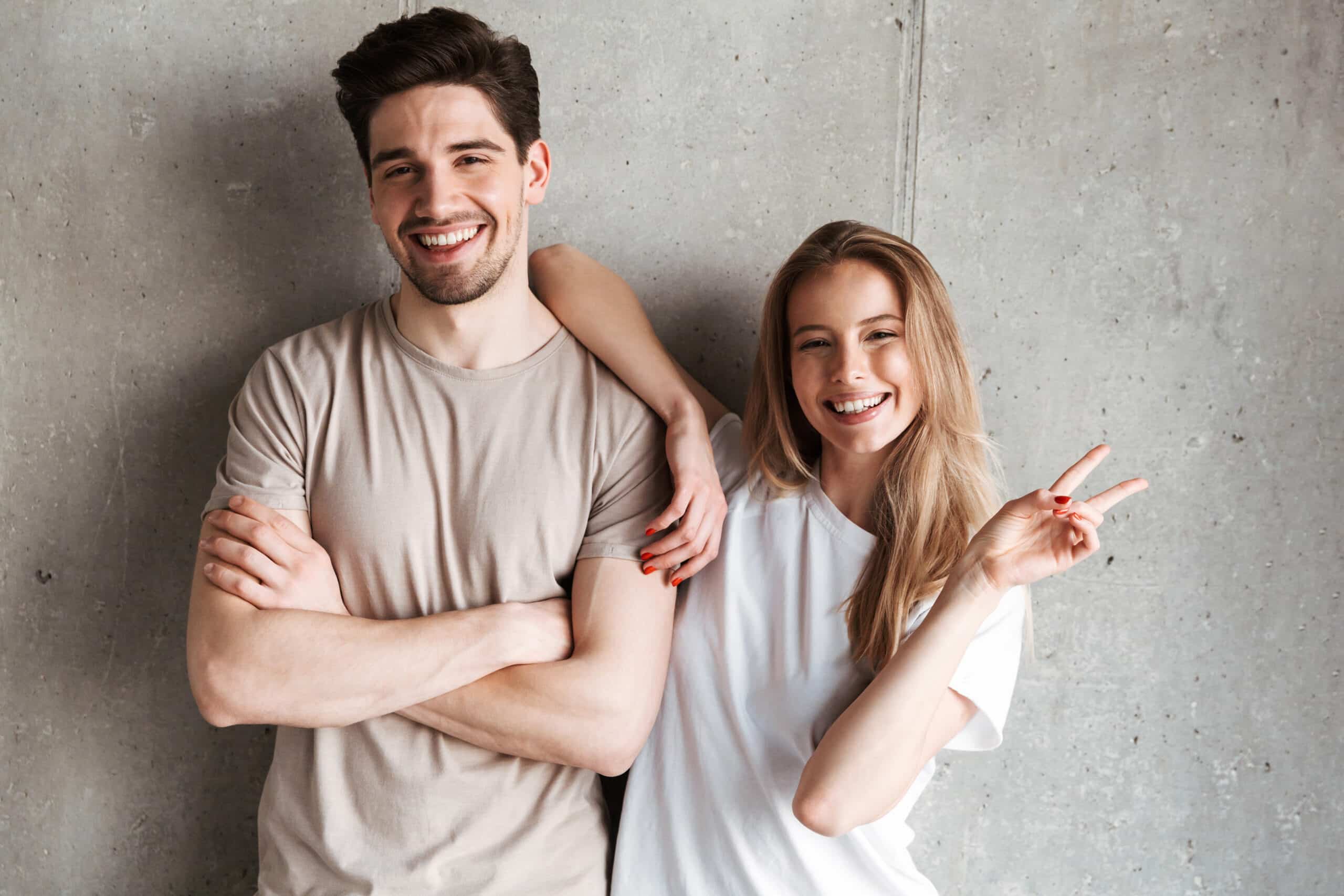 Joyful,Lovely,Couple,Girl,And,Guy,In,Basic,Clothing,Posing